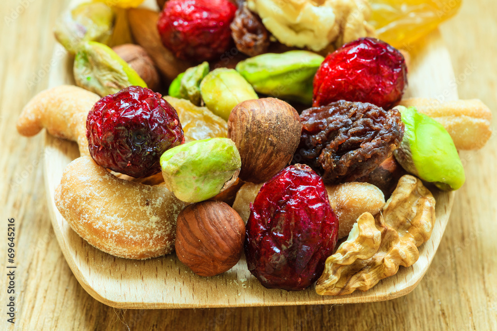 Varieties of dried fruits and nuts on wooden spoon. Varieties of dried fruits and nuts on wooden spoon.