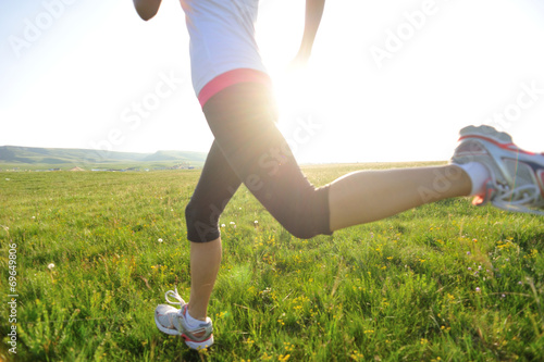 Runner athlete running on grass seaside