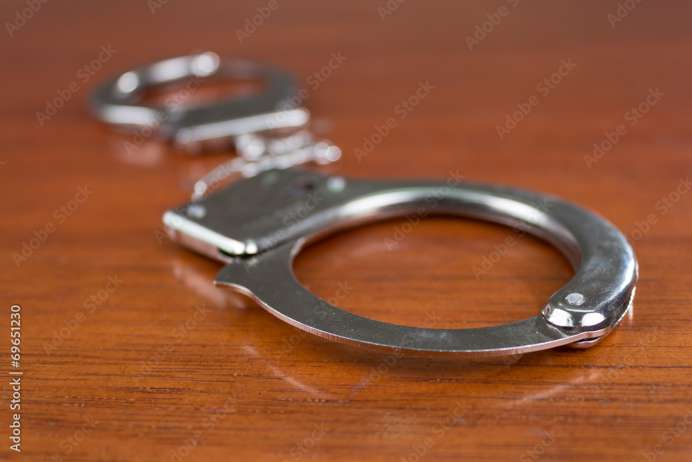 Closeup shot of metallic handcuffs Closeup shot of metallic handcuffs