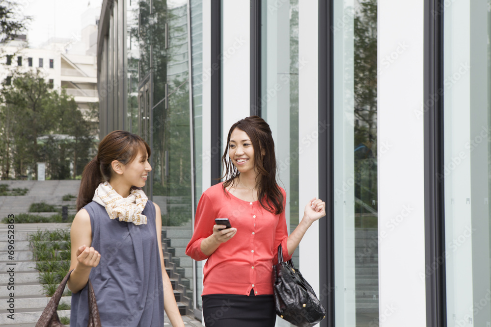 Modern building , Two young women Modern building , Two young women