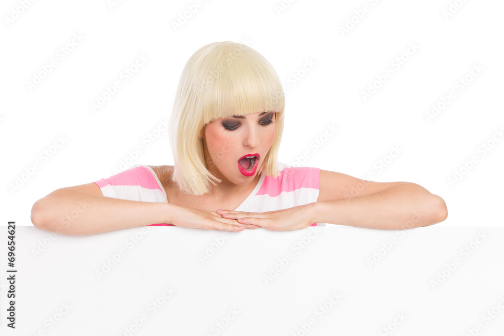 Surprised blonde behind a banner