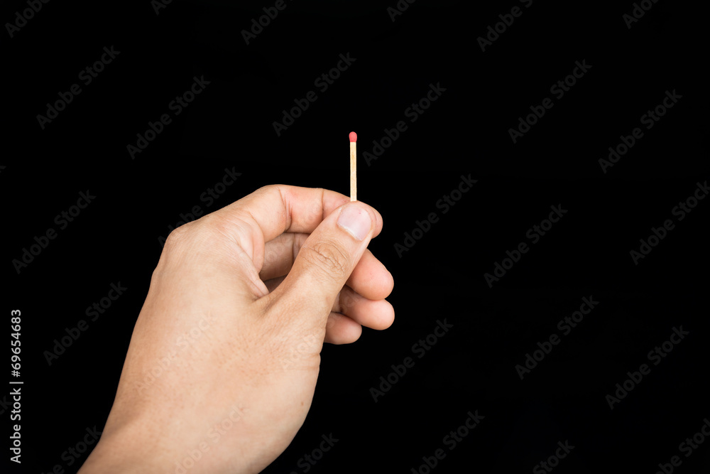 Matchstick in hand isolated on black background Matchstick in hand isolated on black background