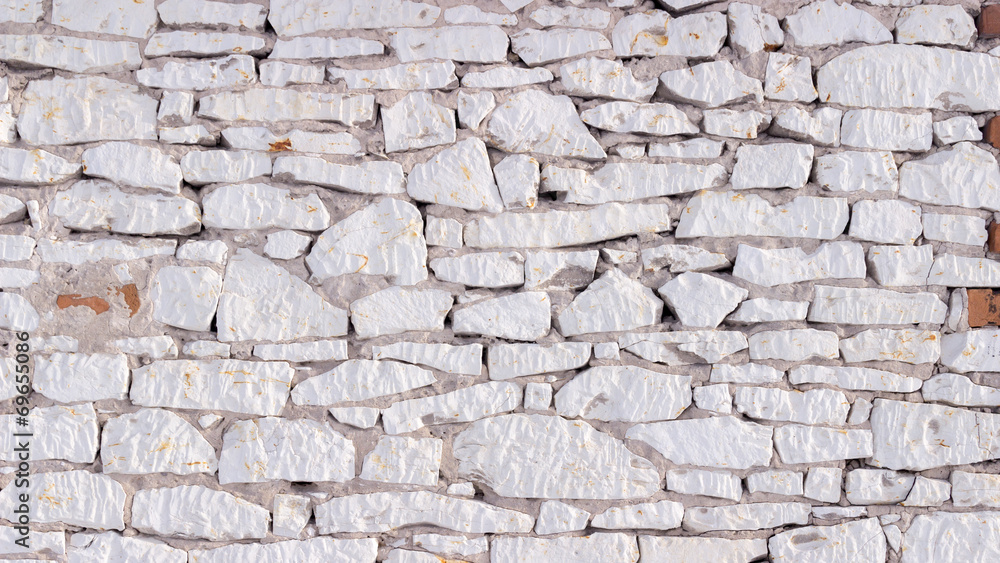 Fototapeta premium Part of a white stone wall, for background or texture.