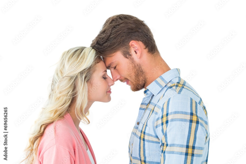 Attractive couple standing touching heads Attractive couple standing touching heads