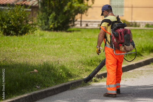 Man using electric leaf blowers