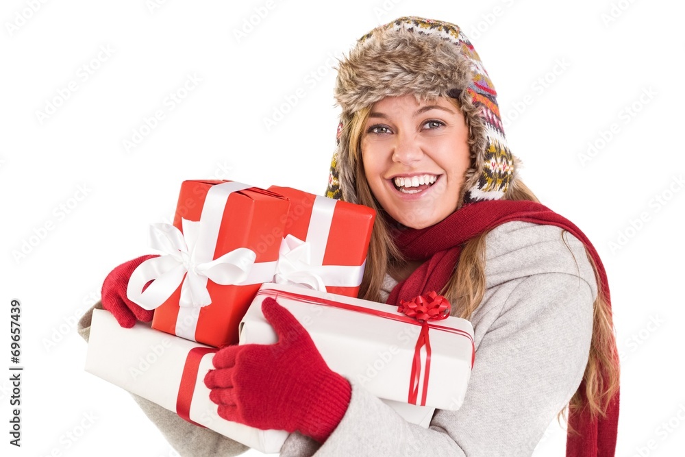 Happy blonde in winter clothes holding gifts Happy blonde in winter clothes holding gifts