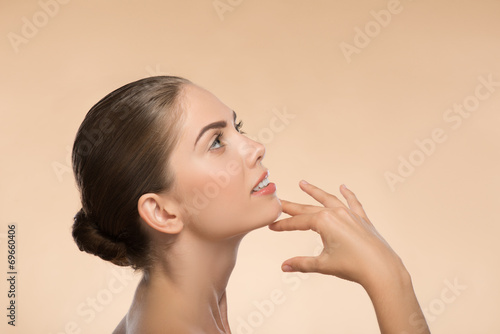 Portrait of girl holding hands near her face with clean and fre