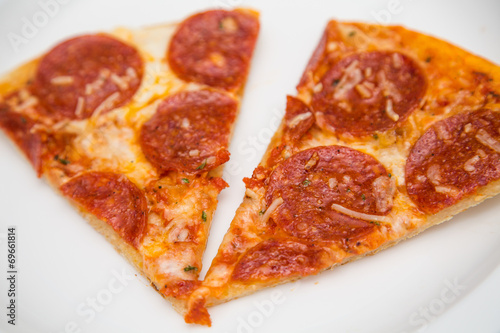 Two Slices of Pepperoni Pizza on White Plate