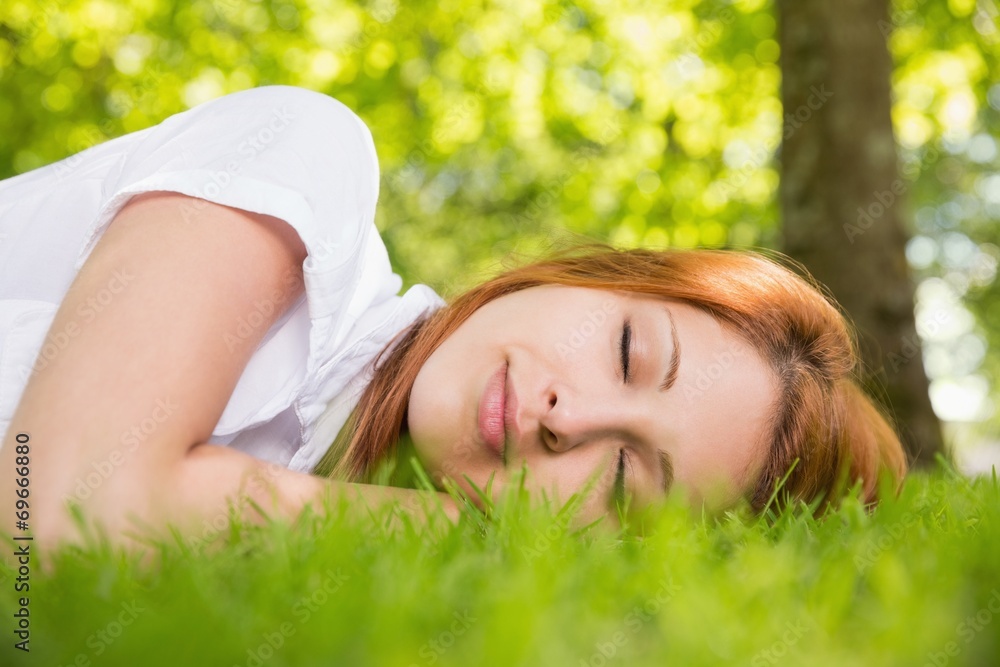 Pretty redhead lying on the grass Pretty redhead lying on the grass