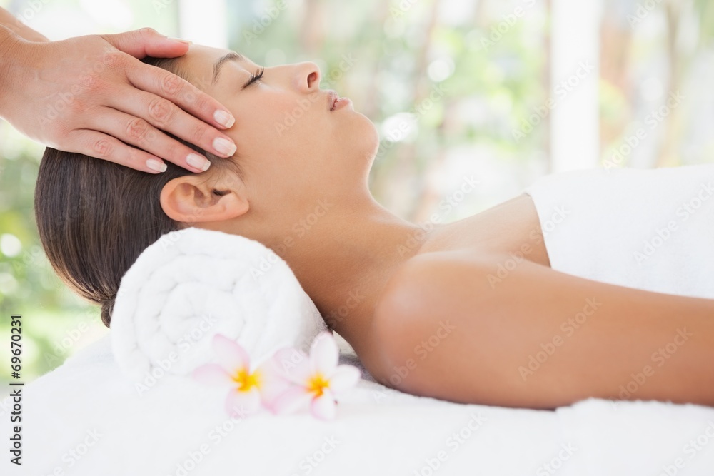 Beautiful brunette enjoying a head massage Beautiful brunette enjoying a head massage