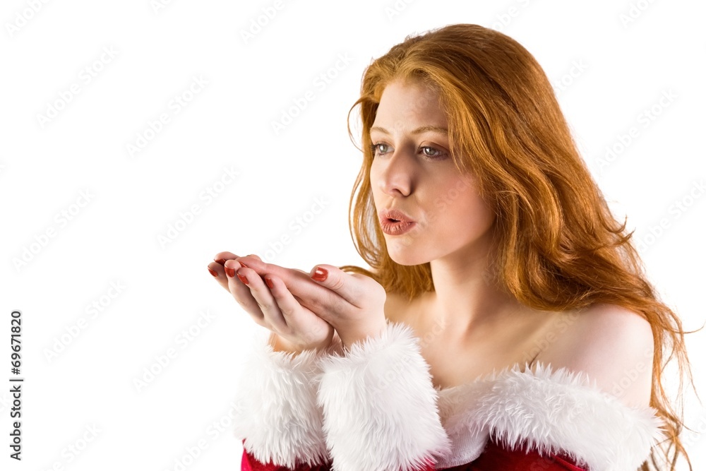 Festive redhead blowing over hands Festive redhead blowing over hands