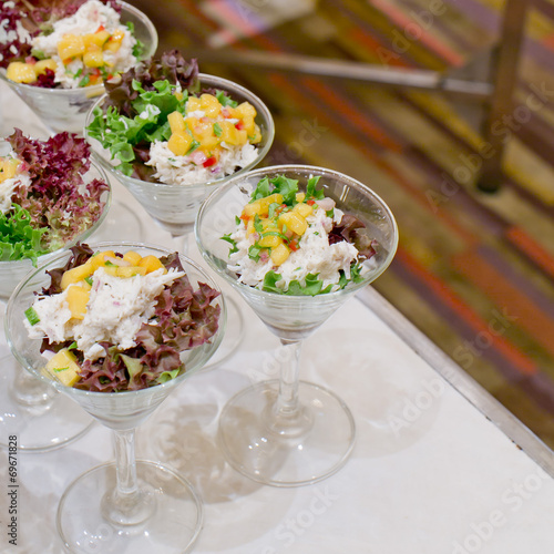 Appetizing salad in a transparent salad bowl, food closeup