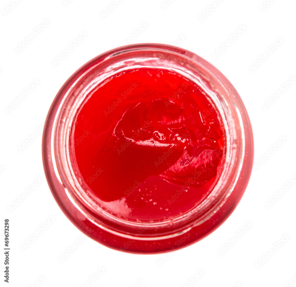 A bottle of strawberry jam over white background 