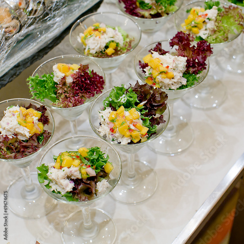 Appetizing salad in a transparent salad bowl, food closeup