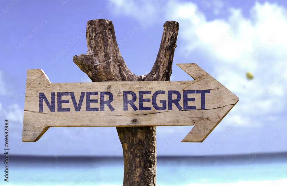 Never Regret wooden sign with a beach on background
