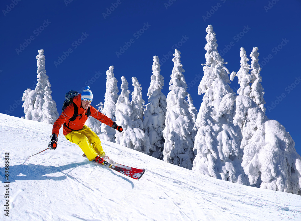 Skier against blue sky in high mountains