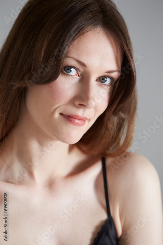 Studio Portrait Of Beautiful Woman Against Black Background