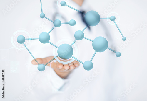 close up of male doctor hand with molecules photo