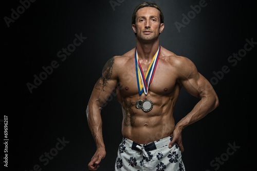 Middle Age Athlete Competitor Showing His Winning Medal