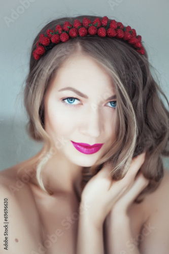 Portrait of beautiful woman with flowers in hair and blue eyes