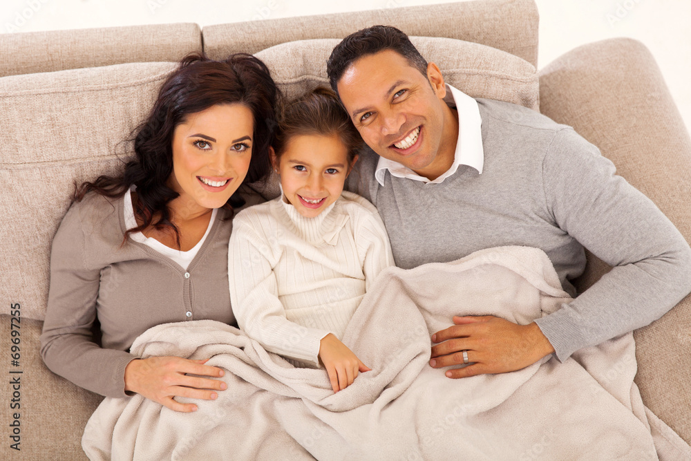 top view of young family lying on the couch top view of young family lying on the couch