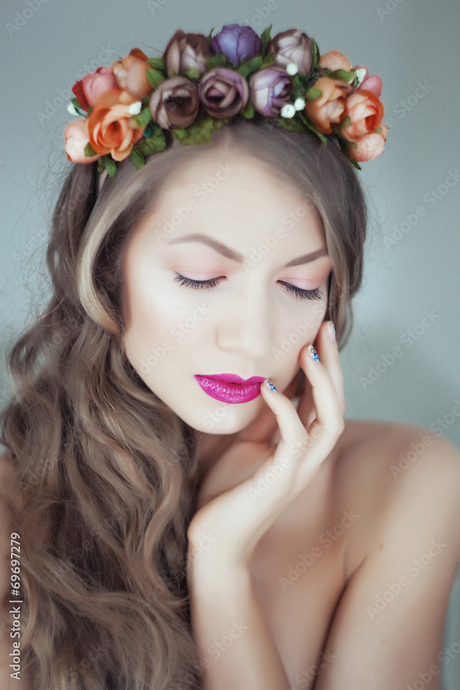 Young beautiful woman with flowers in hair and blue eyes Young beautiful woman with flowers in hair and blue eyes