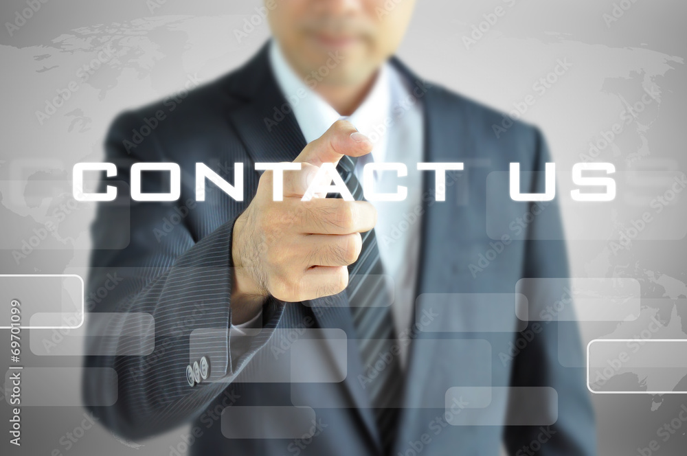 Businessman pointing to CONTACT US sign on virtual screen Businessman pointing to CONTACT US sign on virtual screen