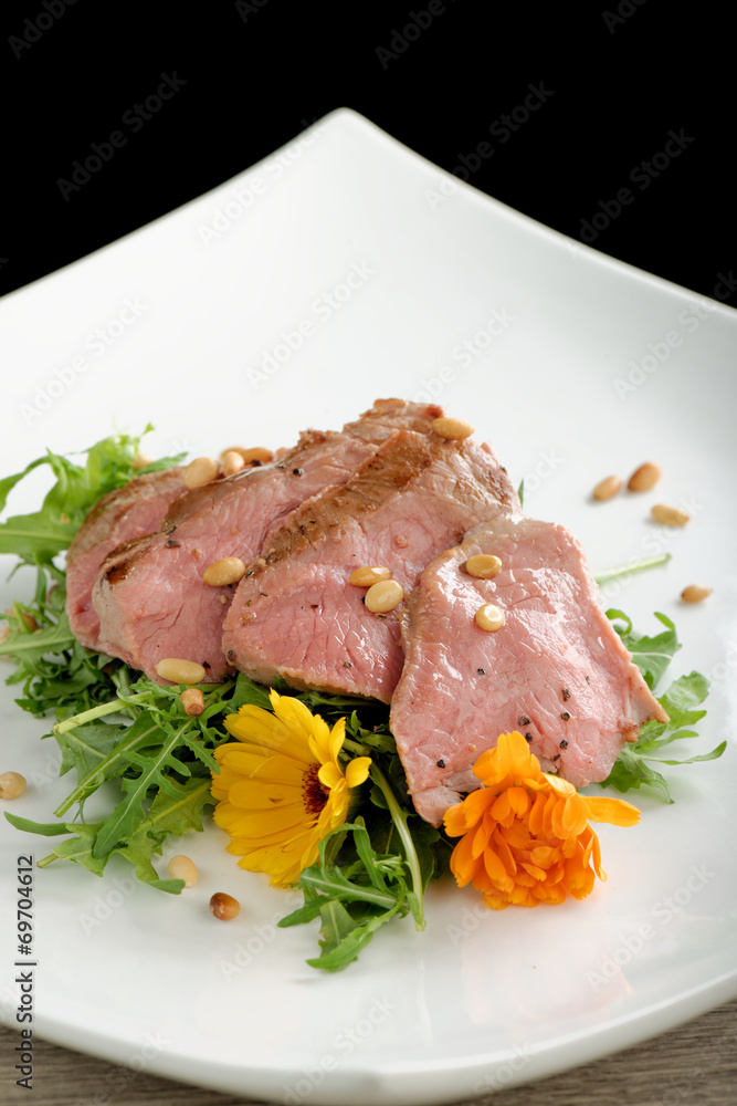 Tagliata roast beef on rocket salad
