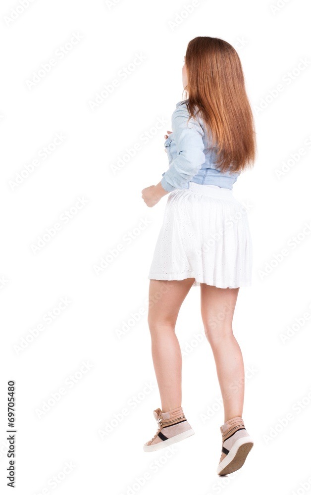 back view of running woman. beautiful redhead girl in motion. back view of running woman. beautiful redhead girl in motion.