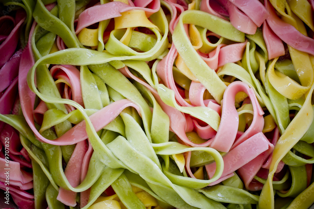 Background of colorful pasta as texture, close-up. Mixed colors