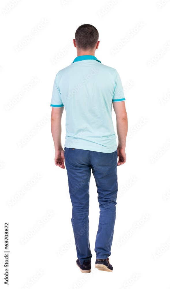Back view of going handsome man in jeans and a shirt. Back view of going handsome man in jeans and a shirt.