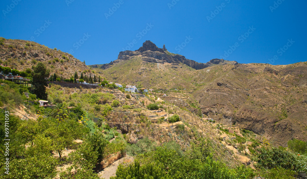 Roque Nublo seen over Tejeda village