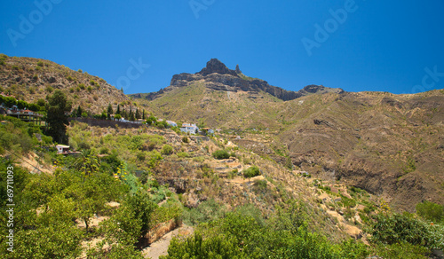 Roque Nublo seen over Tejeda village