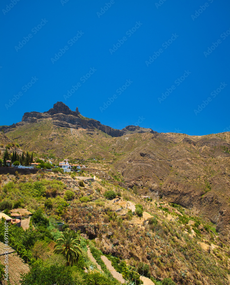 Roque Nublo seen over Tejeda village