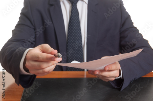 Businessman offering pen and documents for signing