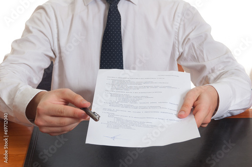 Businessman offering pen and documents for signing