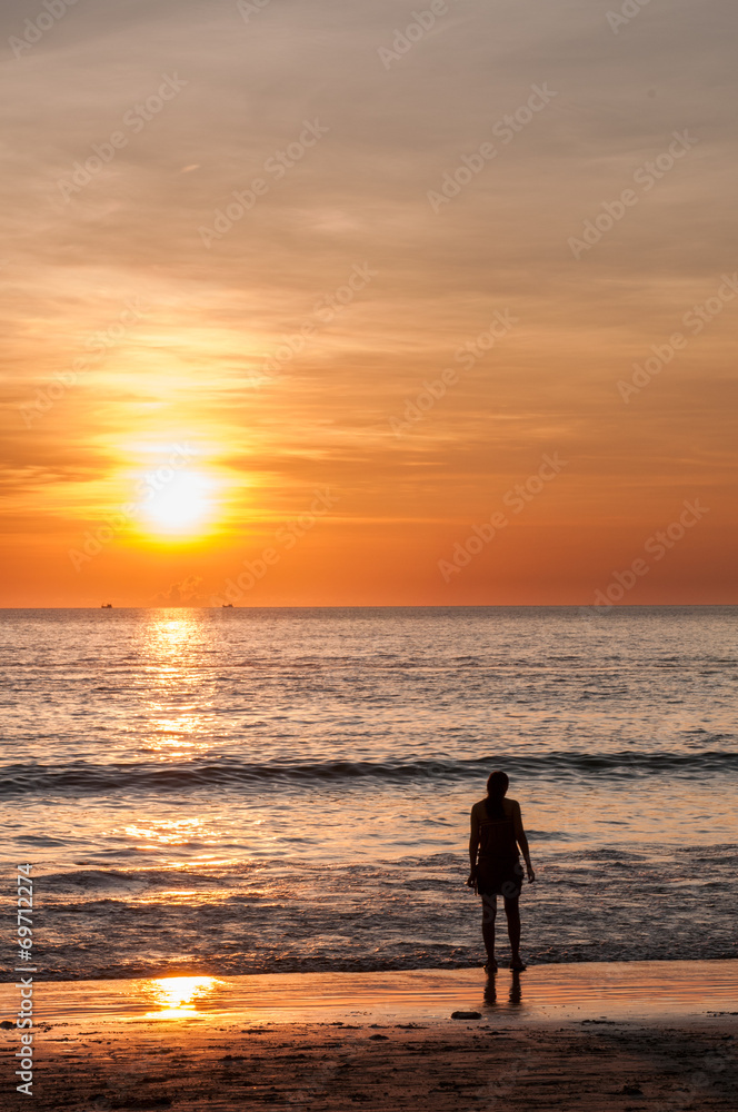 beautiful sunset beach with a young woman