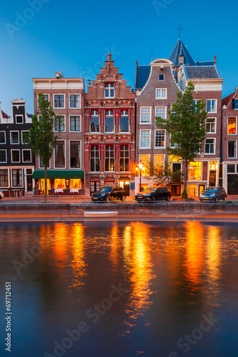 Night city view of Amsterdam canal with dutch houses