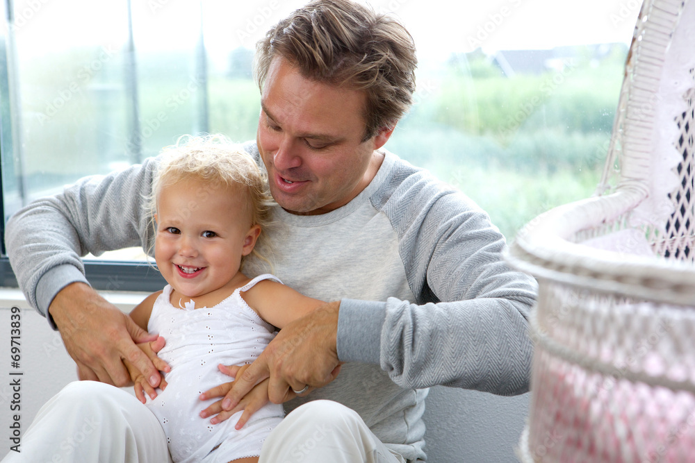 Obraz premium Happy father playing with baby daughter