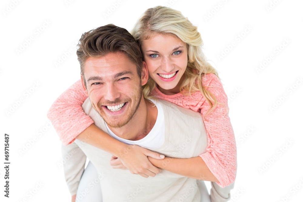 Handsome man giving piggy back to his girlfriend Handsome man giving piggy back to his girlfriend