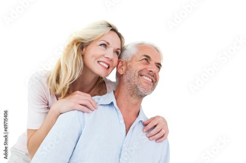 Smiling couple embracing and looking