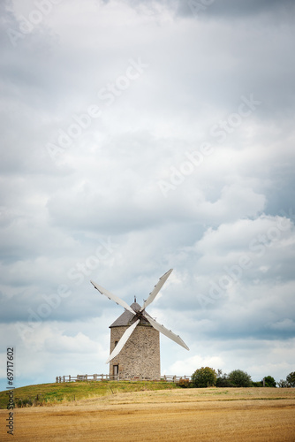 Old windmill against cloudy sky. Brittany  France.