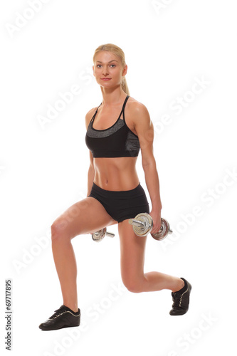 Sexy athletic blonde girl with dumbbells