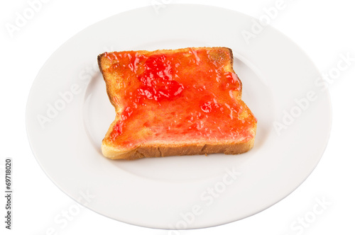 Bread toast with strawberry jam on white plate