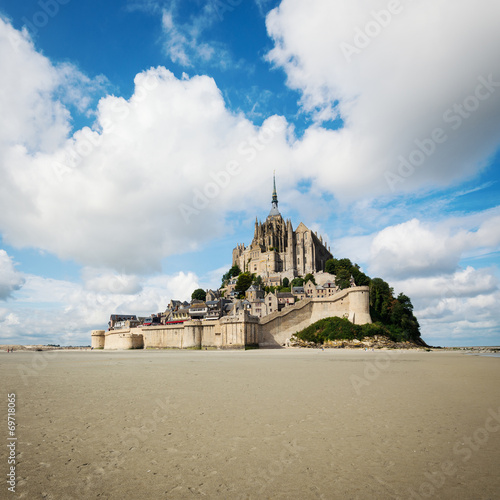 Mont Saint Michel ancient village with dramatic sky. Normandy, F