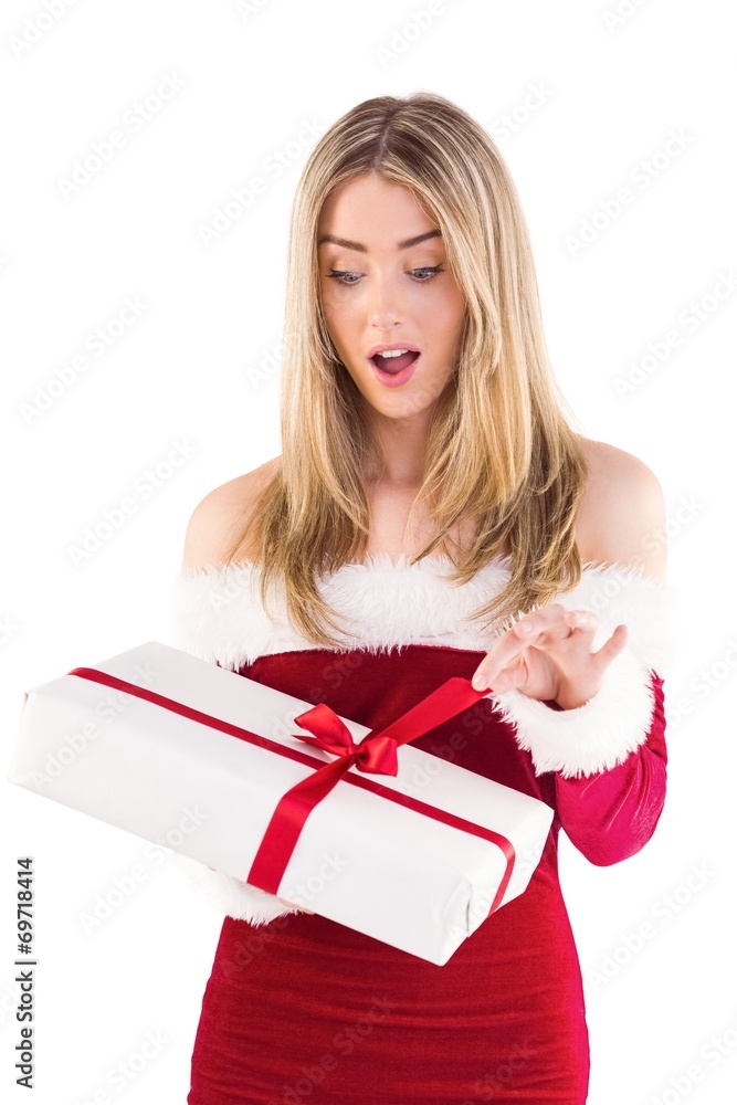 Pretty santa girl opening gift Pretty santa girl opening gift