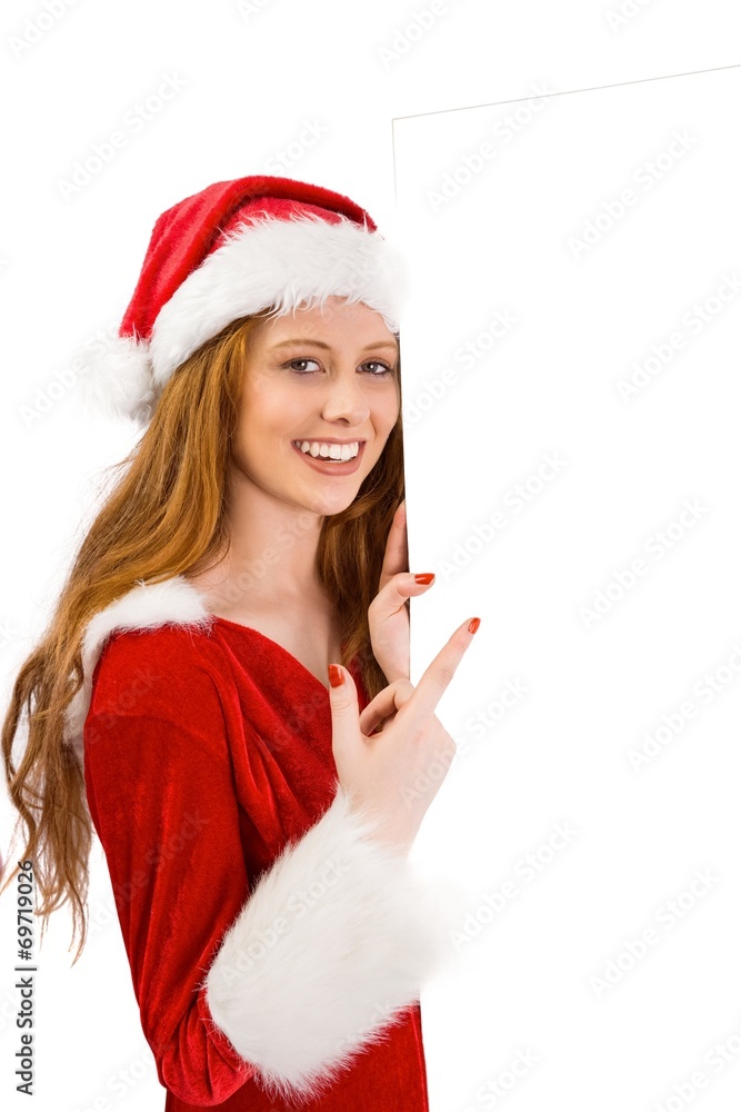 Festive redhead smiling at camera holding poster Festive redhead smiling at camera holding poster