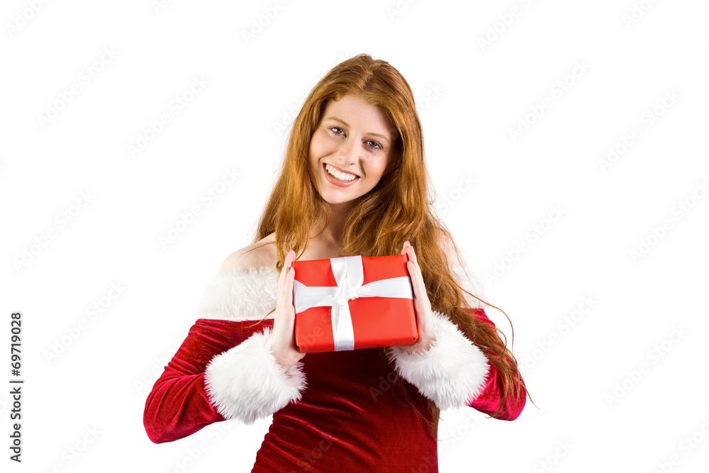 Fototapeta premium Festive redhead holding a gift