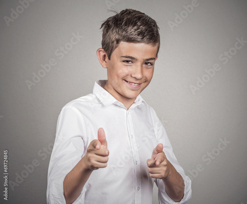 Smiling man giving two thumbs up pointing fingers at camera