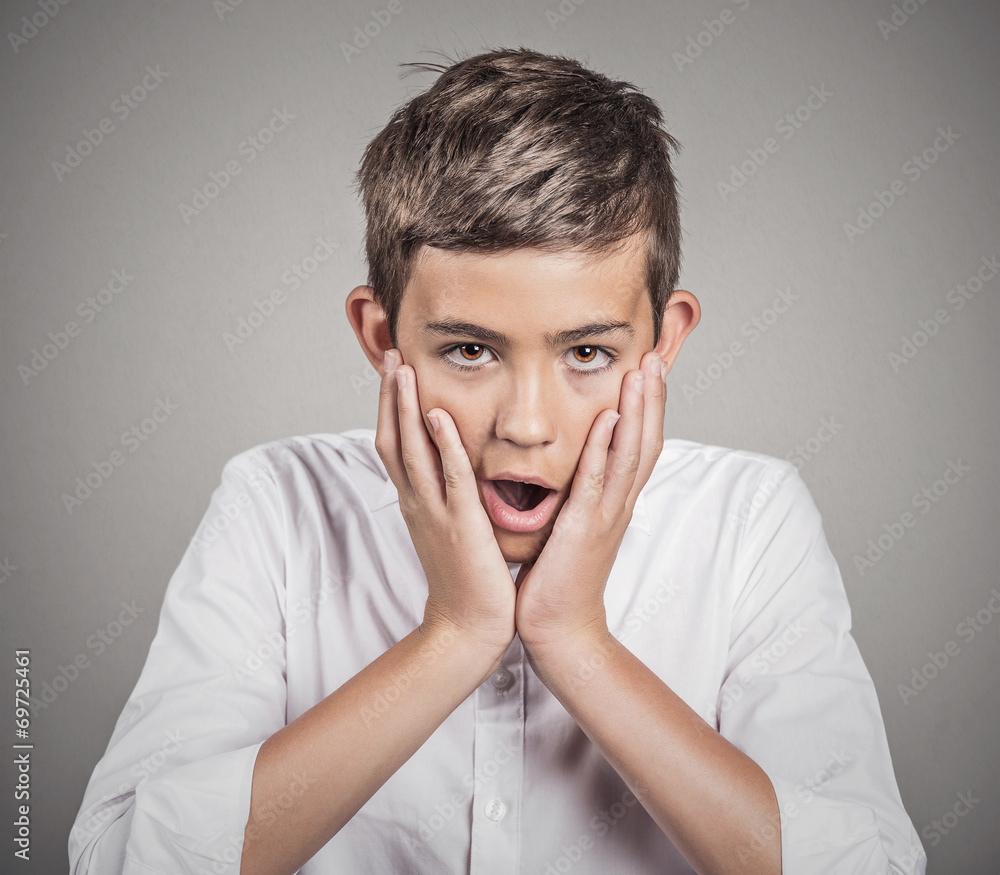 Boy shocked surprised in disbelief hands on cheeks Boy shocked surprised in disbelief hands on cheeks